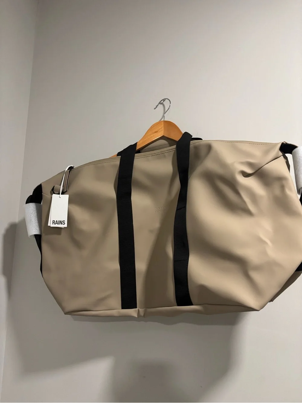Rains Hilo Duffel Bag in Taupe with Black Straps